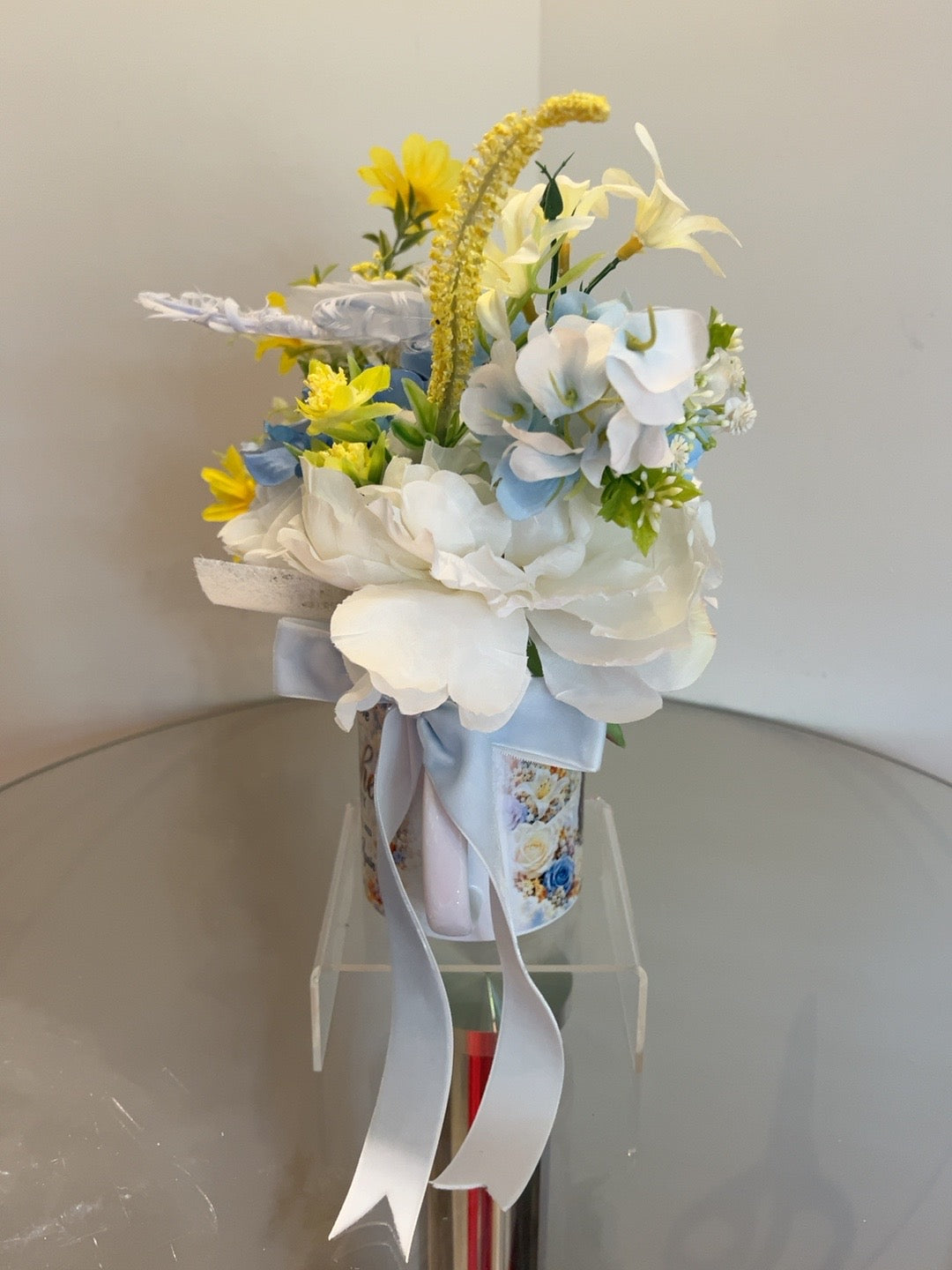 Original side view $99.99 Signature Floral package with blue and white flowers and satin bow